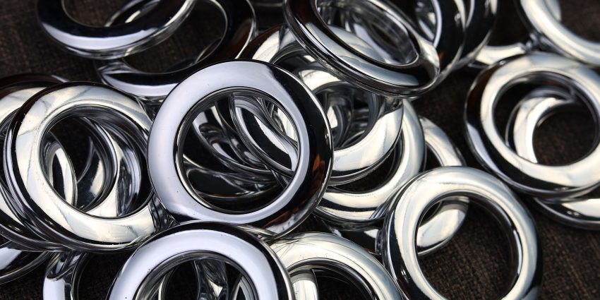 Pile of chrome metal grommet rings close up